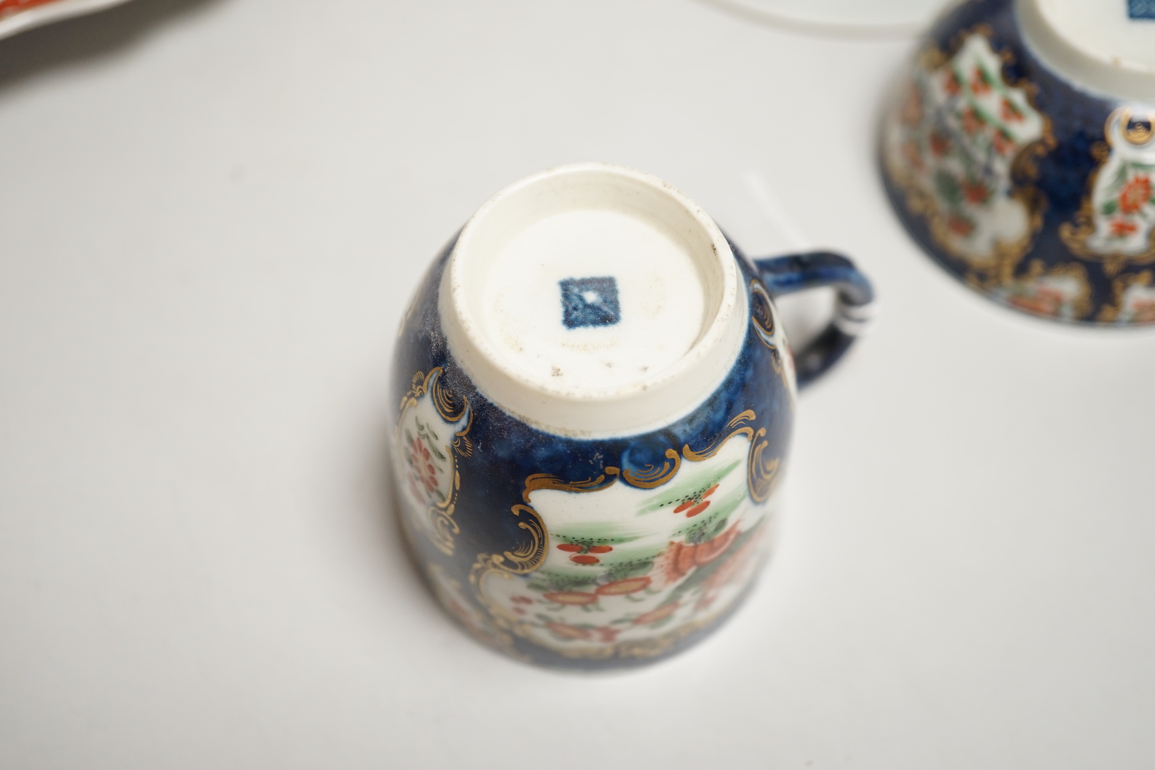 A Worcester kakiemon style scale blue trio, c.1770, a Worcester Queen Charlotte’s pattern plate, 19.5 cm and a Samson saucer in Worcester style